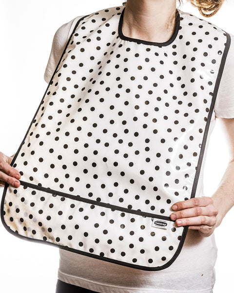 Oilcloth Adult Bib black polka dots on solid white background with solid black trim and crumb catcher