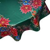 Round oilcloth tablecloth in Poinsettias on green